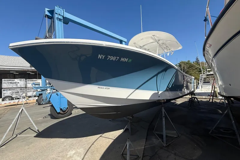  Yacht Photos Pics 2017 Regulator 25 boat on stands, blue hull, NY registration visible.