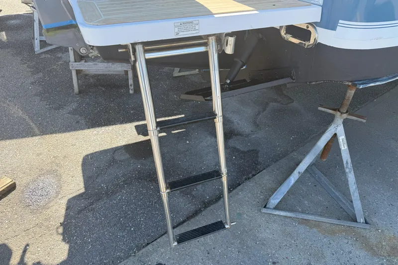  Yacht Photos Pics Stainless steel ladder on a 2017 Regulator 25 boat, resting on a stand.
