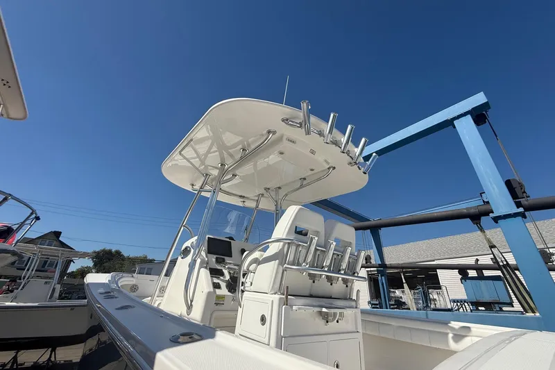 Yacht Photos Pics 2017 Regulator 25 boat with T-top and rod holders under clear blue sky.