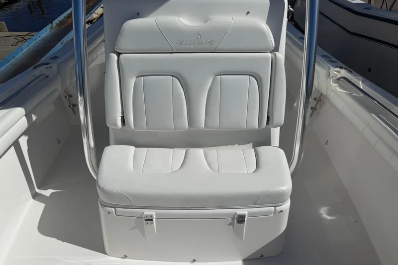  Yacht Photos Pics 2017 Regulator 25 boat seat with white cushioned upholstery and stainless steel frame.