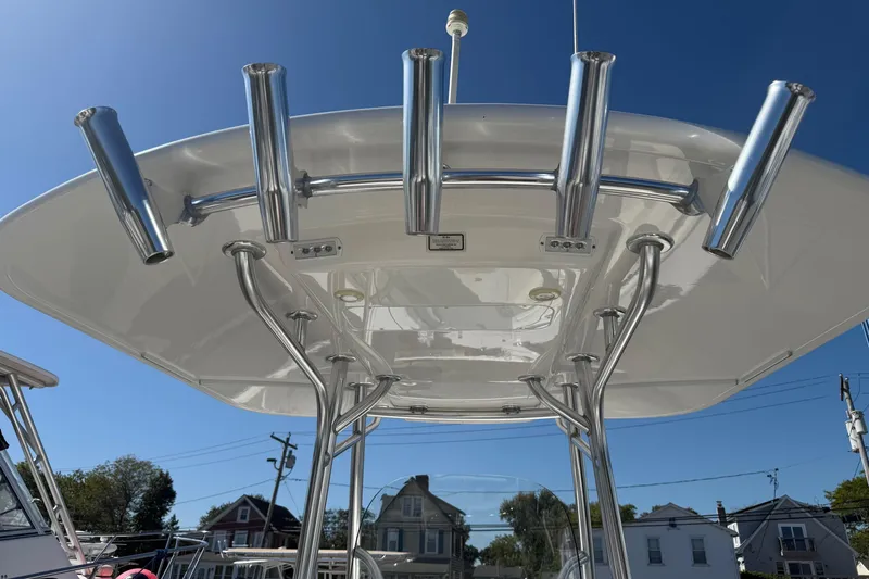  Yacht Photos Pics 2017 Regulator 25 boat with T-top and rod holders under clear blue sky.