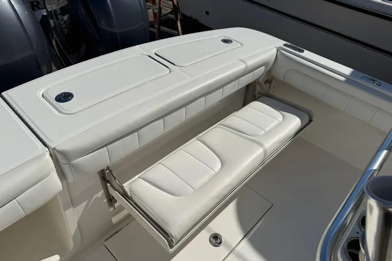  Yacht Photos Pics 2017 Regulator 25 boat with white cushioned seating and storage compartments.