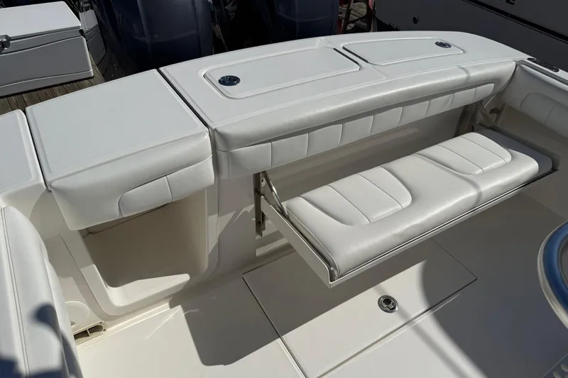  Yacht Photos Pics 2017 Regulator 25 boat with white cushioned seating and storage compartments.