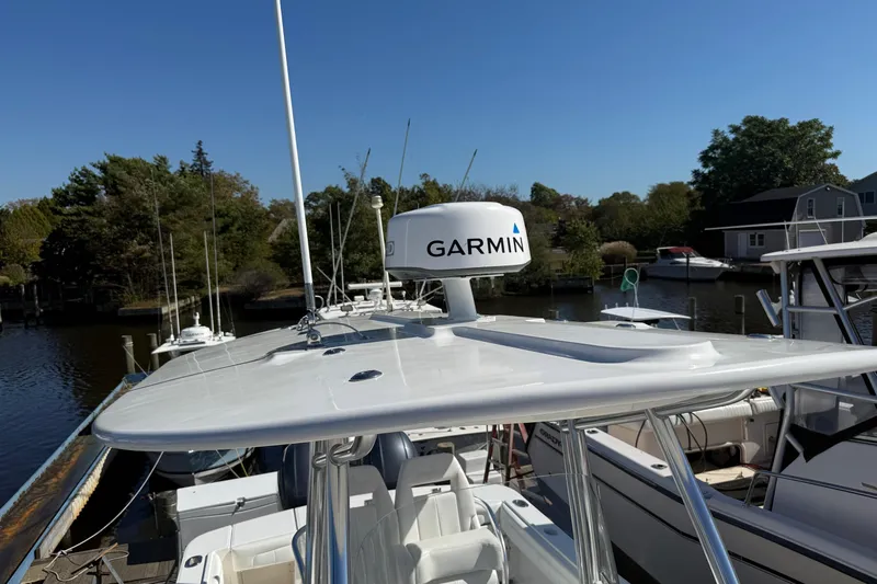  Yacht Photos Pics 2017 Regulator 25 boat with Garmin radar, docked in a serene marina setting.