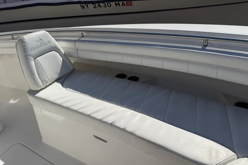  Yacht Photos Pics 2017 Regulator 25 boat interior with white cushioned seating and sleek design.