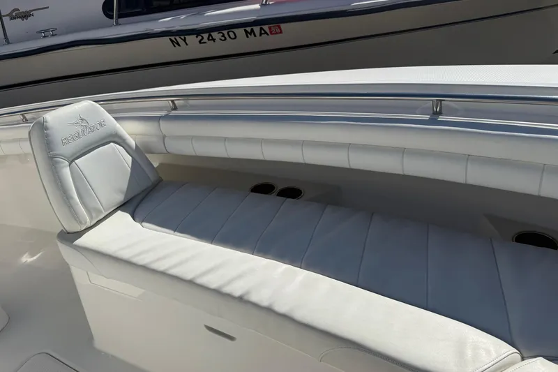  Yacht Photos Pics 2017 Regulator 25 boat with white cushioned seating and sleek design.