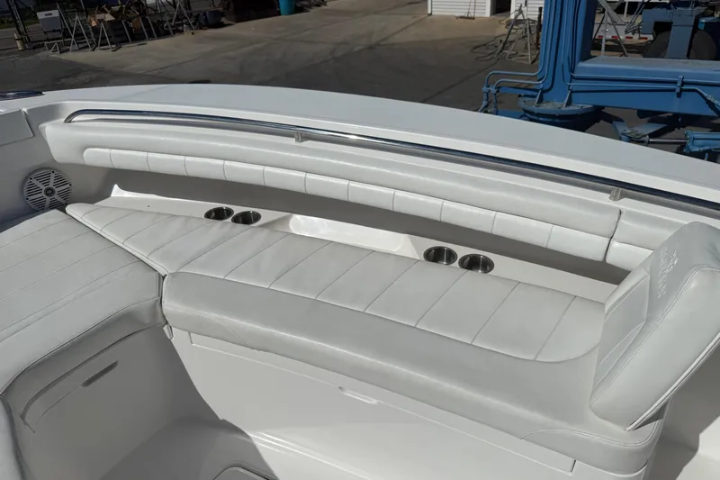  Yacht Photos Pics 2017 Regulator 25 boat interior with white cushioned seating and cup holders.