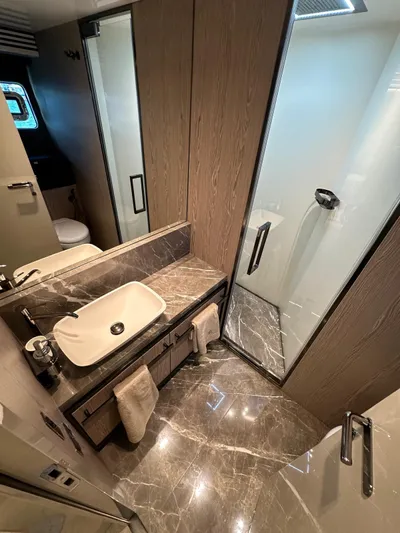  Yacht Photos Pics Luxurious bathroom in 2023 Cranchi Settantotto 78 yacht with marble finishes and modern fixtures.