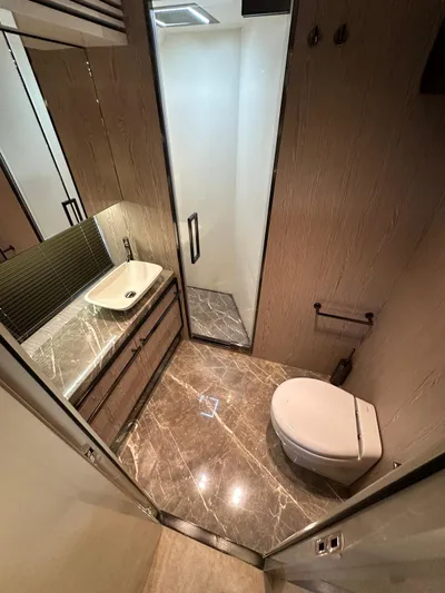  Yacht Photos Pics Luxurious bathroom in 2023 Cranchi Settantotto 78 yacht with modern fixtures and marble flooring.