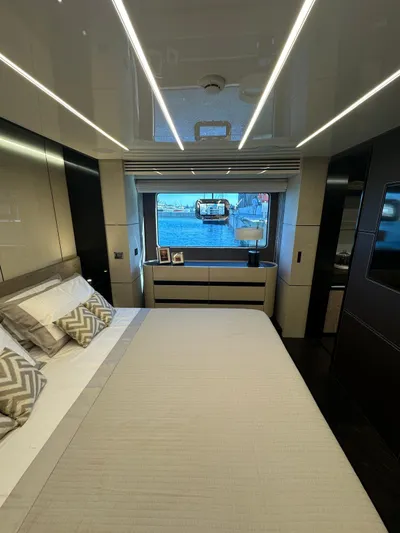  Yacht Photos Pics Luxurious bedroom interior of 2023 Cranchi Settantotto 78 yacht with modern design and large window.