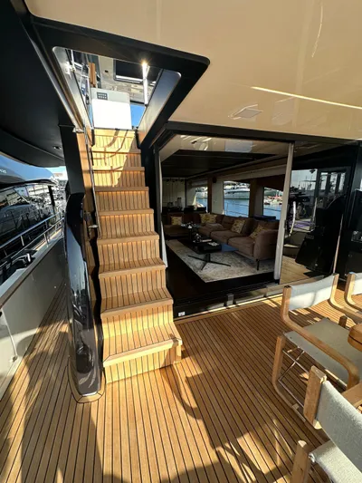  Yacht Photos Pics Luxury interior of 2023 Cranchi Settantotto 78 yacht with wooden deck and staircase.
