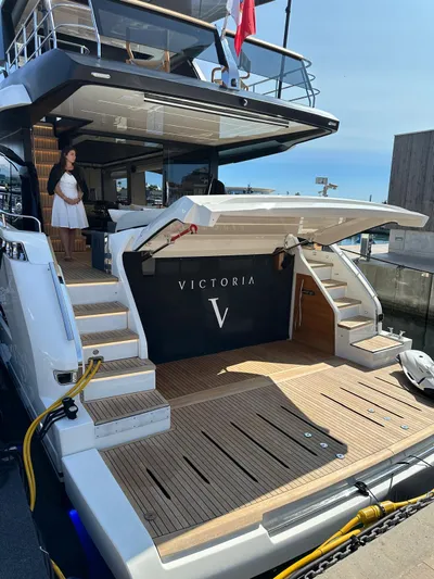 Yacht Photos Pics 2023 Cranchi Settantotto 78 yacht docked, featuring elegant design and spacious deck area.