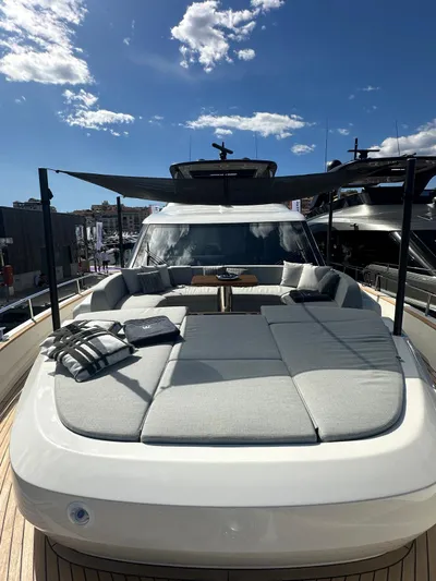  Yacht Photos Pics 2023 Cranchi Settantotto 78 yacht with luxurious sunbathing deck under clear blue sky.