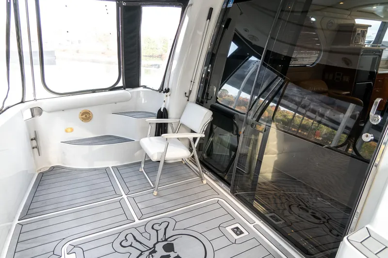  Yacht Photos Pics 2000 Carver 450 Voyager Pilothouse yacht deck with chair and skull-themed flooring.