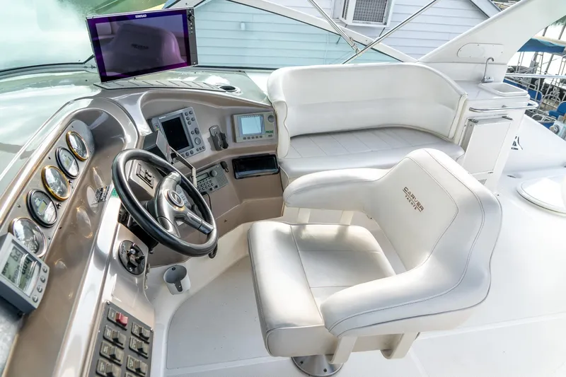  Yacht Photos Pics Pilothouse of 2000 Carver 450 Voyager with steering wheel, gauges, and seating.