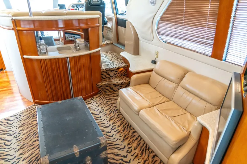 Yacht Photos Pics Interior of 2000 Carver 450 Voyager Pilothouse with leather seating and zebra-patterned carpet.