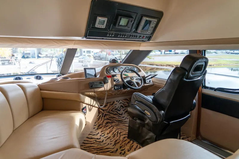  Yacht Photos Pics Interior of 2000 Carver 450 Voyager Pilothouse with leather seating and zebra-patterned carpet.