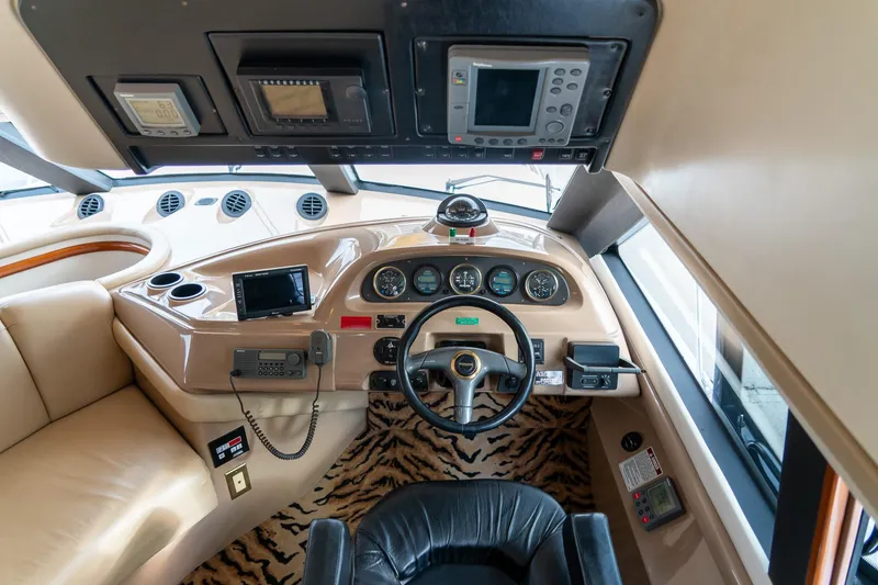  Yacht Photos Pics Interior of 2000 Carver 450 Voyager Pilothouse with steering wheel and navigation equipment.