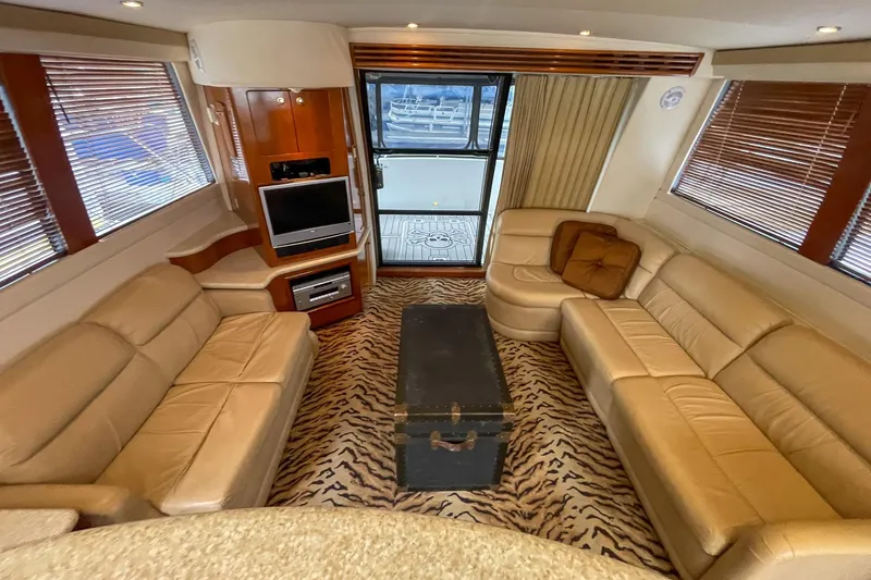  Yacht Photos Pics Luxurious interior of 2000 Carver 450 Voyager Pilothouse with leather seating and zebra-patterned carpet.