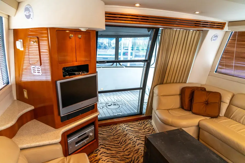  Yacht Photos Pics Luxurious interior of 2000 Carver 450 Voyager Pilothouse with leather seating and entertainment system.