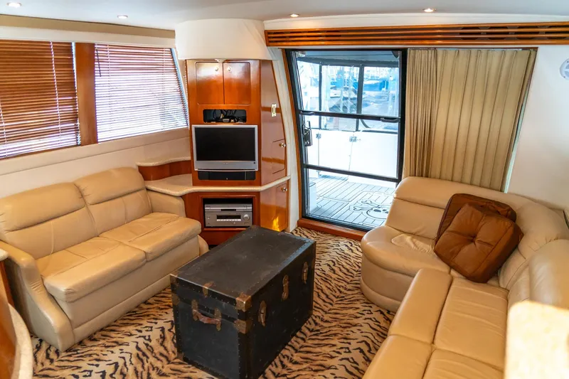  Yacht Photos Pics Luxurious interior of 2000 Carver 450 Voyager Pilothouse with plush seating and entertainment center.