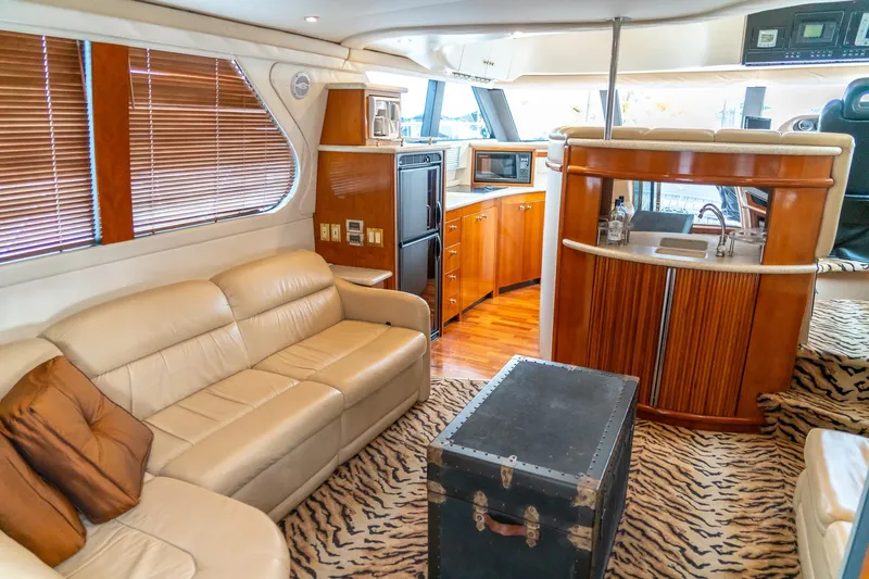  Yacht Photos Pics Luxurious interior of 2000 Carver 450 Voyager Pilothouse with leather seating and kitchenette.