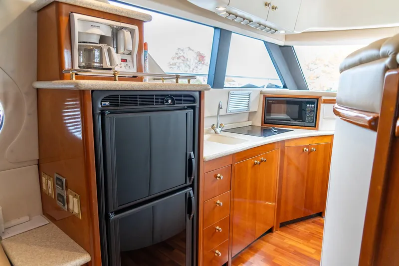  Yacht Photos Pics Luxurious kitchen in 2000 Carver 450 Voyager Pilothouse with appliances and wood cabinetry.