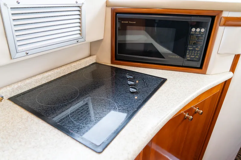  Yacht Photos Pics Modern kitchen in 2000 Carver 450 Voyager Pilothouse with stovetop and microwave.