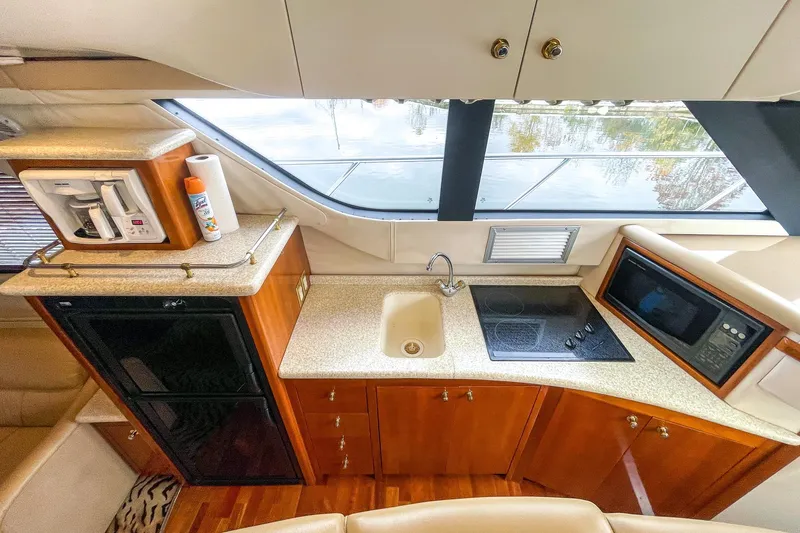  Yacht Photos Pics Luxurious kitchen interior of 2000 Carver 450 Voyager Pilothouse yacht with modern amenities.