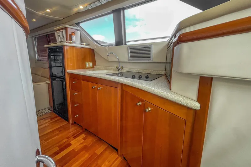  Yacht Photos Pics Luxurious kitchen interior of 2000 Carver 450 Voyager Pilothouse yacht with wood cabinetry.