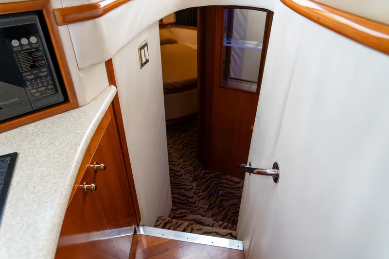  Yacht Photos Pics Interior of 2000 Carver 450 Voyager Pilothouse with wood accents and patterned carpet.