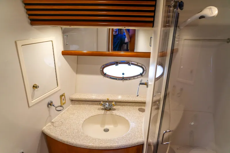  Yacht Photos Pics Bathroom interior of 2000 Carver 450 Voyager Pilothouse with sink and porthole window.