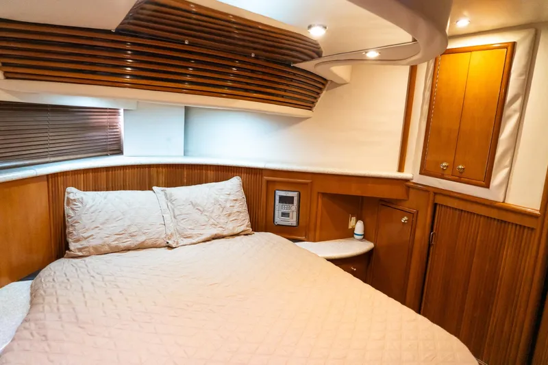 Yacht Photos Pics Luxurious bedroom interior of 2000 Carver 450 Voyager Pilothouse yacht with wood accents.