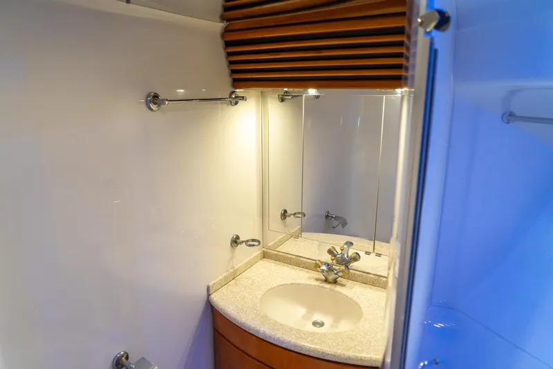 Yacht Photos Pics Bathroom vanity in 2000 Carver 450 Voyager Pilothouse yacht, featuring a sink and mirror.