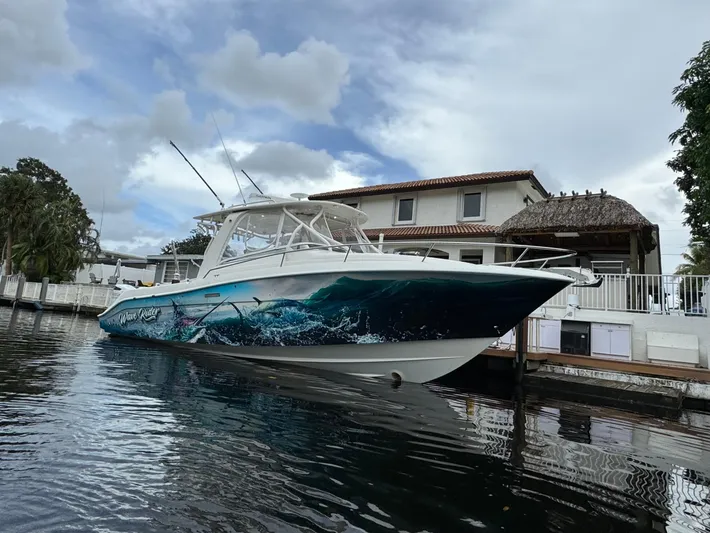  Yacht Photos Pics 2010 Hydra-Sports 3500 VX boat docked by a waterfront house under cloudy skies.