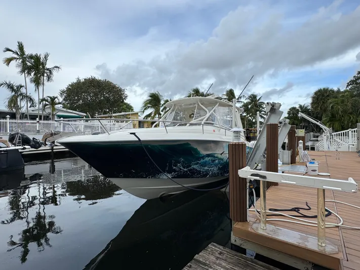  Yacht Photos Pics 2010 Hydra-Sports 3500 VX boat docked by a wooden pier, surrounded by palm trees.