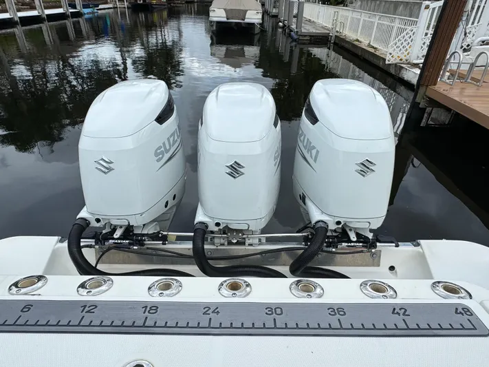  Yacht Photos Pics Triple Suzuki outboard engines on a 2010 Hydra-Sports 3500 VX boat at a dock.