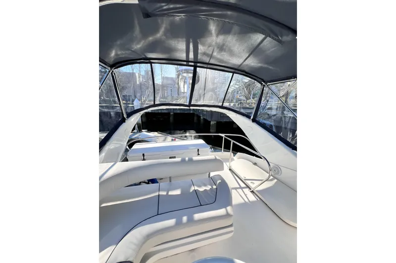 Rising Tide Yacht Photos Pics 1996 Sea Ray 400 Sedan Bridge interior with seating and helm, under canopy.