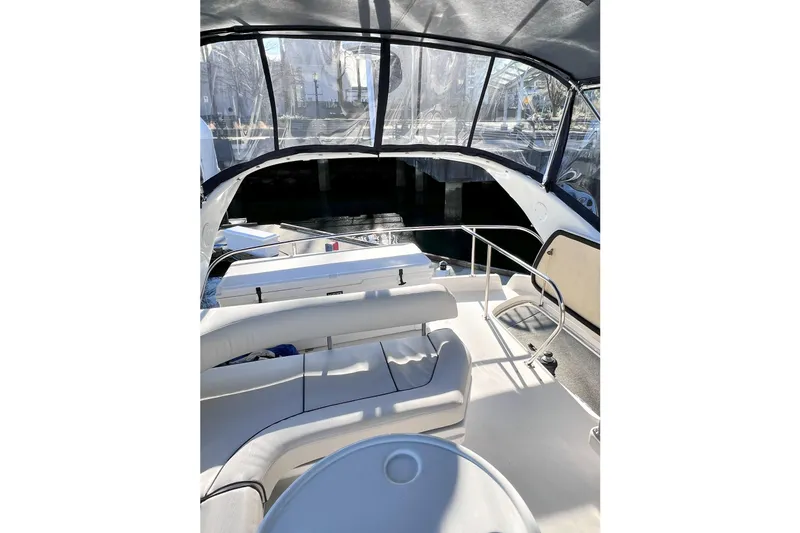 Rising Tide Yacht Photos Pics 1996 Sea Ray 400 Sedan Bridge interior with seating and clear canopy.