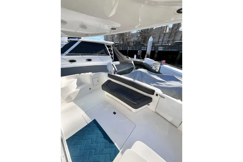 Rising Tide Yacht Photos Pics 1996 Sea Ray 400 Sedan Bridge yacht interior with seating and blue mat.