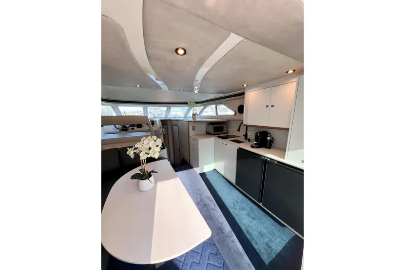 Rising Tide Yacht Photos Pics Interior of 1996 Sea Ray 400 Sedan Bridge yacht, featuring modern kitchen and dining area.
