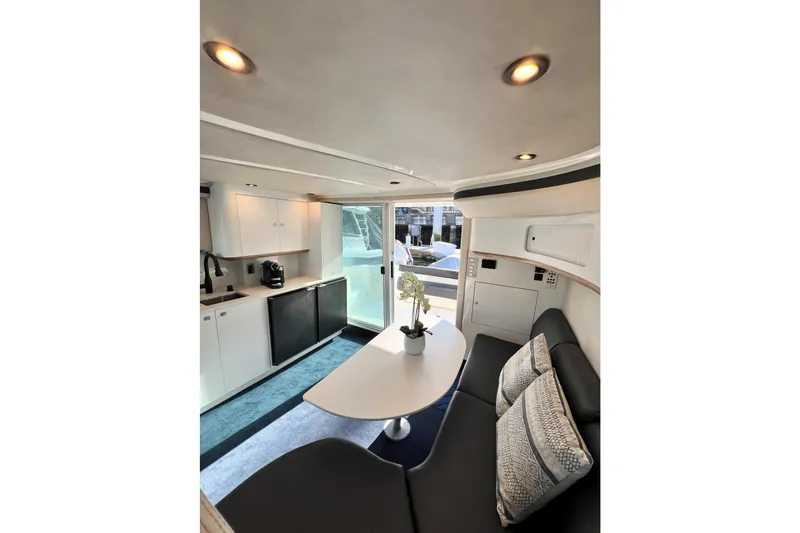 Rising Tide Yacht Photos Pics Interior of 1996 Sea Ray 400 Sedan Bridge yacht with modern kitchen and seating area.