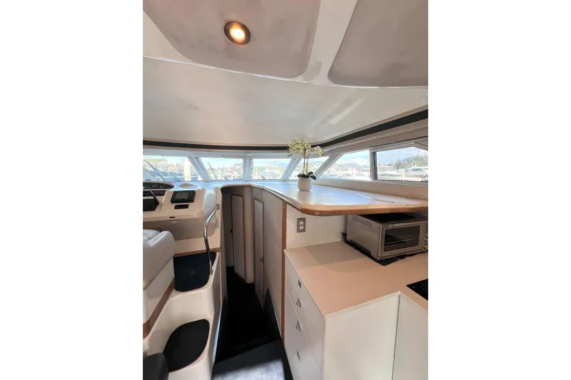 Rising Tide Yacht Photos Pics Interior of 1996 Sea Ray 400 Sedan Bridge yacht with modern kitchen and seating area.