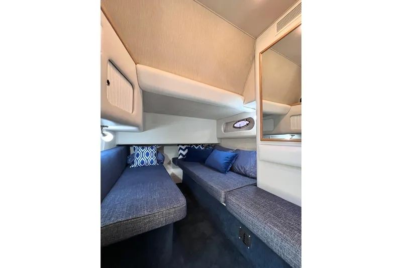 Rising Tide Yacht Photos Pics 1996 Sea Ray 400 Sedan Bridge cabin interior with blue seating and decorative pillows.