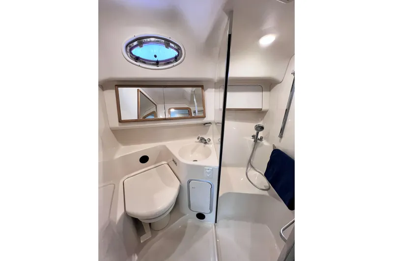 Rising Tide Yacht Photos Pics Bathroom interior of 1996 Sea Ray 400 Sedan Bridge yacht, featuring shower and sink.
