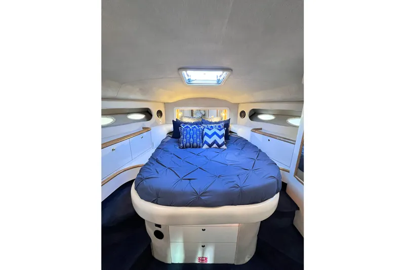 Rising Tide Yacht Photos Pics Luxurious bedroom interior of 1996 Sea Ray 400 Sedan Bridge yacht with blue bedding.
