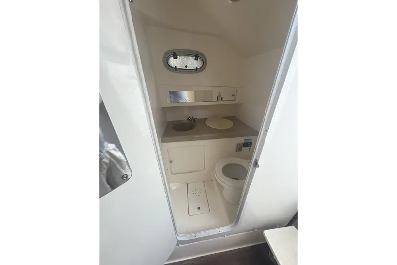  Yacht Photos Pics Interior view of 2002 Boston Whaler 285 Conquest boat bathroom with sink and toilet.
