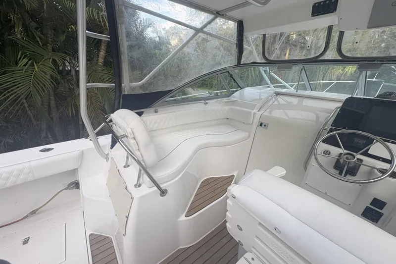  Yacht Photos Pics 2002 Boston Whaler 285 Conquest boat interior with helm and seating area.