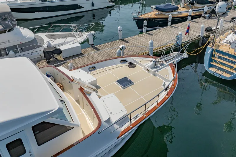Dash Yacht Photos Pics 2016 Grand Banks 72 Aleutian RP yacht docked at marina, showcasing spacious deck.
