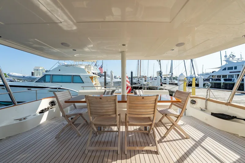 Dash Yacht Photos Pics Outdoor dining area on 2016 Grand Banks 72 Aleutian RP yacht at marina.